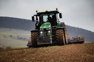 Traktor beim Feld bestellen